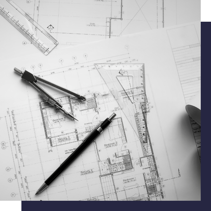 geometra stefano maglione: primo piano di un foglio con un piano catastale, sopra un compasso e una penna.